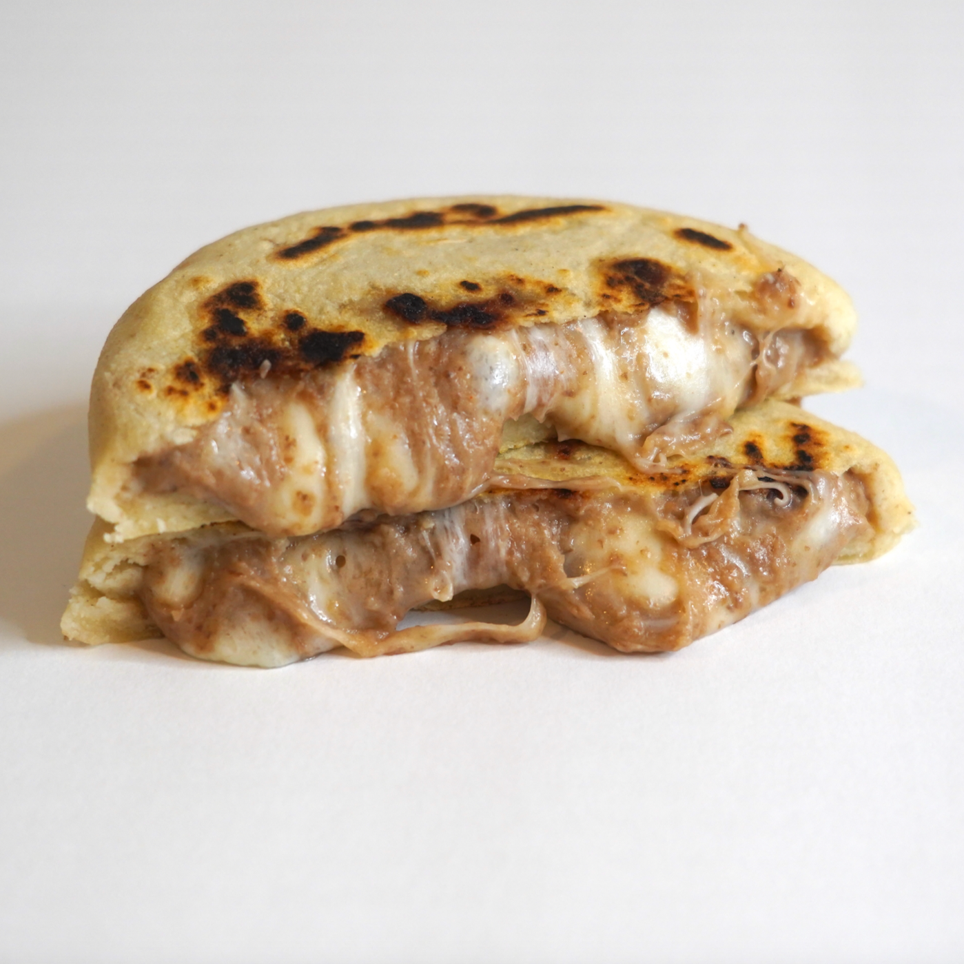 Beans & Cheese Pupusa cut in half